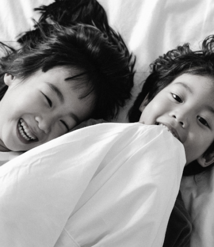 Smiling children laying in Hotel room