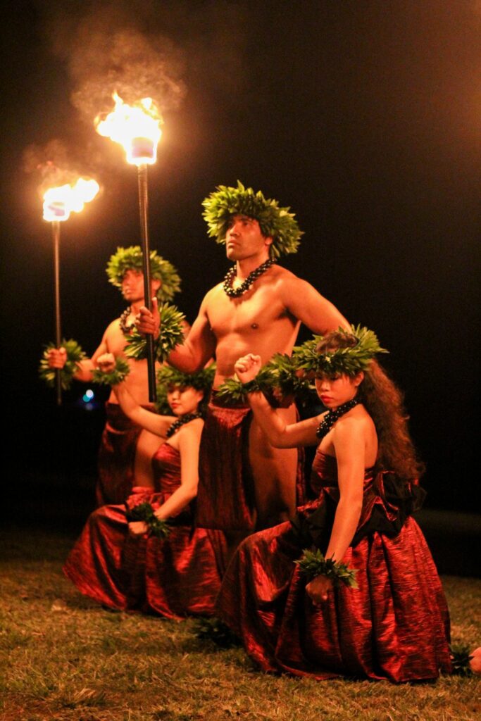 Two men and two women performing a captivating Polynesian fire dance.
