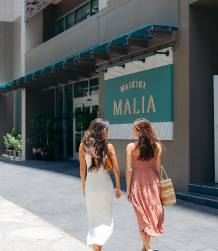 Girls walking near Waikiki Malia on the streets.