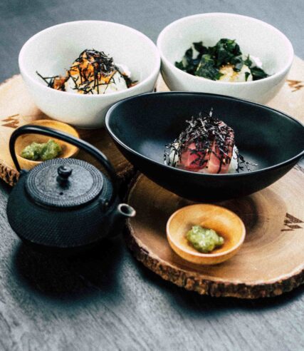 Delicious dishes elegantly presented in lovely bowls on the table.